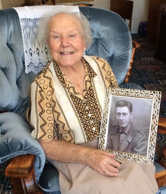 Alma Charnock holding a photo of her late husband Hal