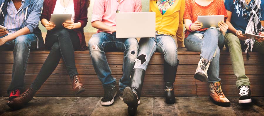 Young people holding laptops