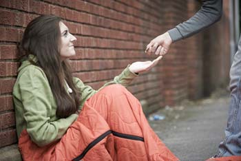 A homeless girl accepts money - photo